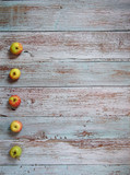 Fototapeta Tulipany - apples on the background of old turquoise boards for list, menu, text or schedule, copy space