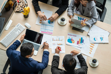 Wall Mural - Business people group meeting shot from top view in office . Profession businesswomen, businessmen and office workers working in team conference with project planning document on meeting table .