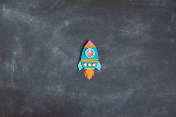 Wall Mural - Rocket paper craft. Back to school education. Black chalkboard background