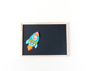 Wall Mural - Rocket paper craft. Back to school education. Black chalkboard background