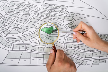 Poster - Close-up Of Human Hand Holding Magnifying Glass