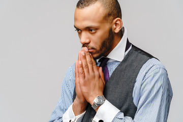 African american man holding hands in prayer hoping for better