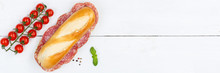 Sub Sandwich Baguette With Salami Copyspace Copy Space Banner From Above On Wooden Board