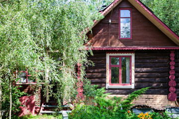 Wall Mural - facade of russian wooden log house on sunny summer day