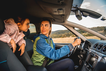 Family driving in car, mother shouting at daughter