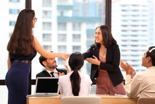 Female Business CEO Congratulate Her Female Employee For The Outstanding Achievement Of Her Team Performance By Shaking Hand With The Rest Of The Team Clapping During Corporate Meeting In The Office 