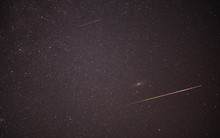 Meteor Shower During Perseid Curent. Andromeda Galaxy In Night Sky