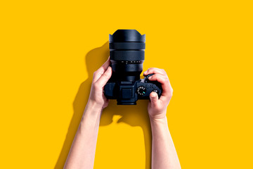 Poster - Person holding a SLR camera from above