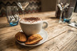 perfect rustic country wooden table cappuccino coffee latte art and madeleine cakes