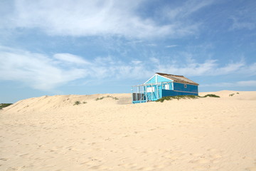 Typical tiny wooden colorful house, in Costa da Caparica, Lisbon, Portugal.