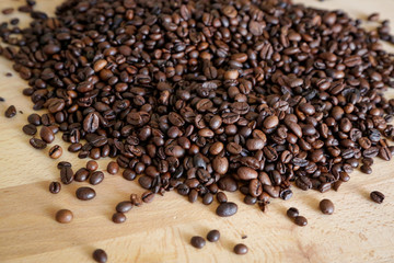 Wall Mural - Coffee grains on wooden table, with natural light