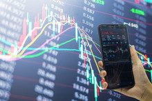 Holding a mobile phone to see stocks and stock securities trading data analysis