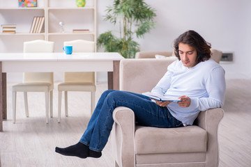 Young male student preparing for exams at home