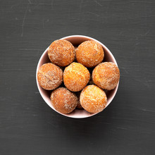 Homemade Fried Donut Holes In A Pink Bowl On A Black Surface, Top View. Flat Lay, Overhead, From Above.