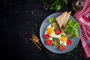 English breakfast - fried eggs, tomatoes and eggplant. American food. Top view, overhead, copy space