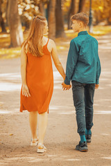 Poster - young couple walks in the park. back view