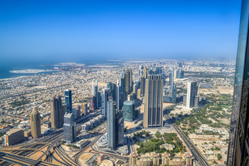 Dubai, United Arab Emirates - September 2, 2016. Urbanistic view of Dubai territories from the top of Burj Khalifa skyscraper, tall buildings on the sunny autumn day