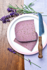 Cheese collection, pieces of violet hard cheese made with aromatic lavender seeds and fresh lavender flowers