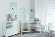 Stylish Baby Room Interior With Crib And Cute Pictures On Wall
