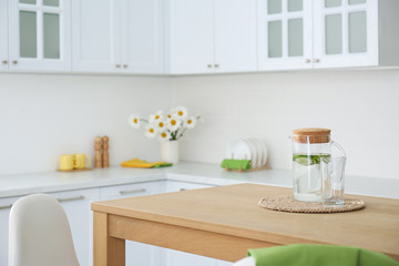 Wall Mural - Stylish wooden table in beautiful kitchen interior