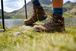 Trekking boots in the mountains and a lake