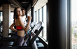 © NDABCREATIVITY - Picture of people running on treadmill in gym