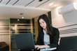 © Near - asian business woman using laptop computer in office