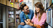 © NDABCREATIVITY - Happy beautiful hipster love student couple taking a selfie in school library.