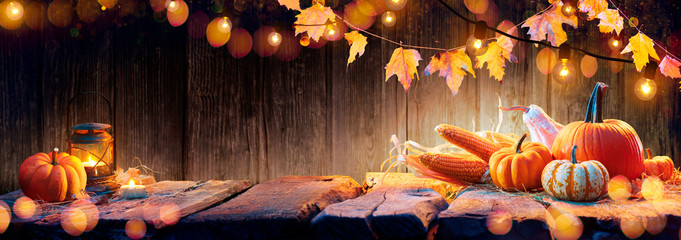 Wall Mural - thanksgiving table - pumpkins and corncobs on wooden plank with garlands