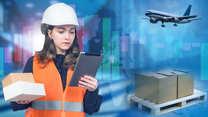 Logistic company. Girl works in logistics business. Woman in orange vest and hard hat. Tracks cargo on Internet. Woman is sending cargo through plane. Air freight cargo. Graph shows rise in prices