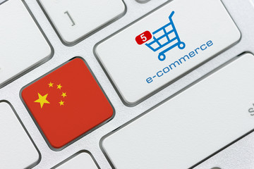 Wall Mural - Online shopping / home shopping / product ordering, ecommerce concept : Flag of China, shopping cart with a word e-commerce on a computer keyboard, depicting buyer buys goods or things via internet