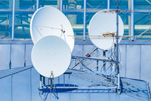 Satellite Television Antennas. Round Satellite Dishes On Roof Of The Building. Several Television Antennas Are Installed Nearby. Equipment For Receiving Tv Signal. Concept - Satellite Television