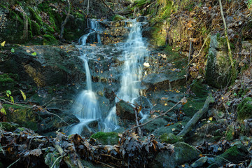 Wall Mural - Beautiful waterfall stream with rocks landscape.