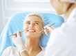 © rogerphoto - Smiling blonde woman examined by dentist at dental clinic. Healthy teeth and medicine concept