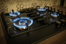 Natural gas burning by blue flames in kitchen stove. Gasification concept.