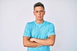 © Krakenimages.com - Young hispanic boy wearing casual clothes skeptic and nervous, disapproving expression on face with crossed arms. negative person.