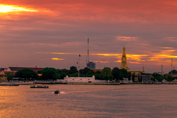 The blurred abstract background of the evening sun shining on the river is naturally golden yellow, the beauty of the clouds and the weather conditions of the day.