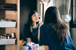 © dodotone - Young adult asian woman makeup and face skincare before mirror at home on day