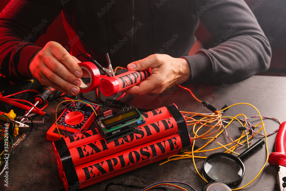 Terrorist making bomb at table Stock Photo | Adobe Stock