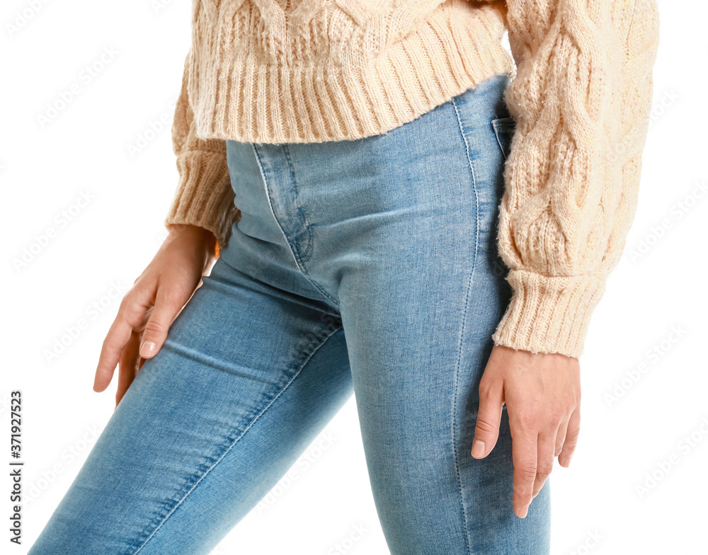Beautiful young woman in jeans on white background