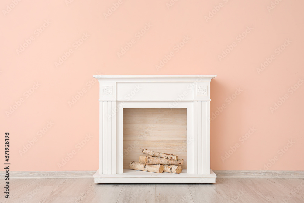 Modern fireplace near wall in room