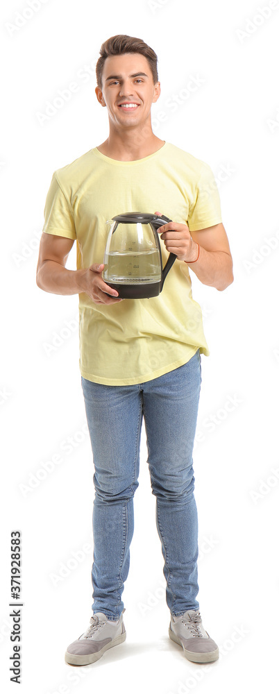 Young man with electric kettle on white background
