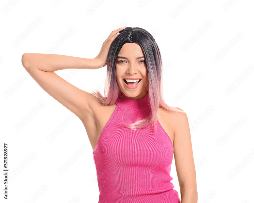 Beautiful young woman in wig on white background