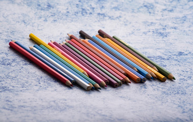 Colored pencils background.Color pencils on blue background.Close up. Many different colored pencils on blue background.Colorful pencil .Colorfull