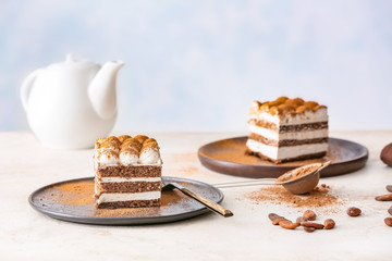 Plates with tasty tiramisu on table