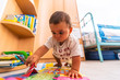 © unai - Young Caucasian mother playing with her in the room with toys. Baby less than a year learning the first lessons of her mother. Boy playing on the floor with toys