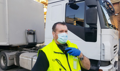 young transporter on the truck with face mask and protective gloves for Coronavirus