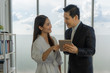 © Siam Stock - Young asian business man and woman using taplet standing at office.