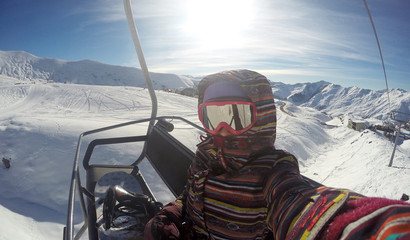 sports lifestyle, winter outdoor recreation, extreme sports, active and healthy recreation, a man on a ski lift in the mountains, nature and a panoramic view of a hill in the snow