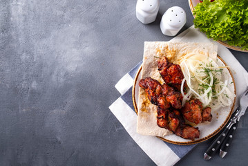 Wall Mural - Bbq meat with onion on a plate. Kebabs, Copy space. Top view